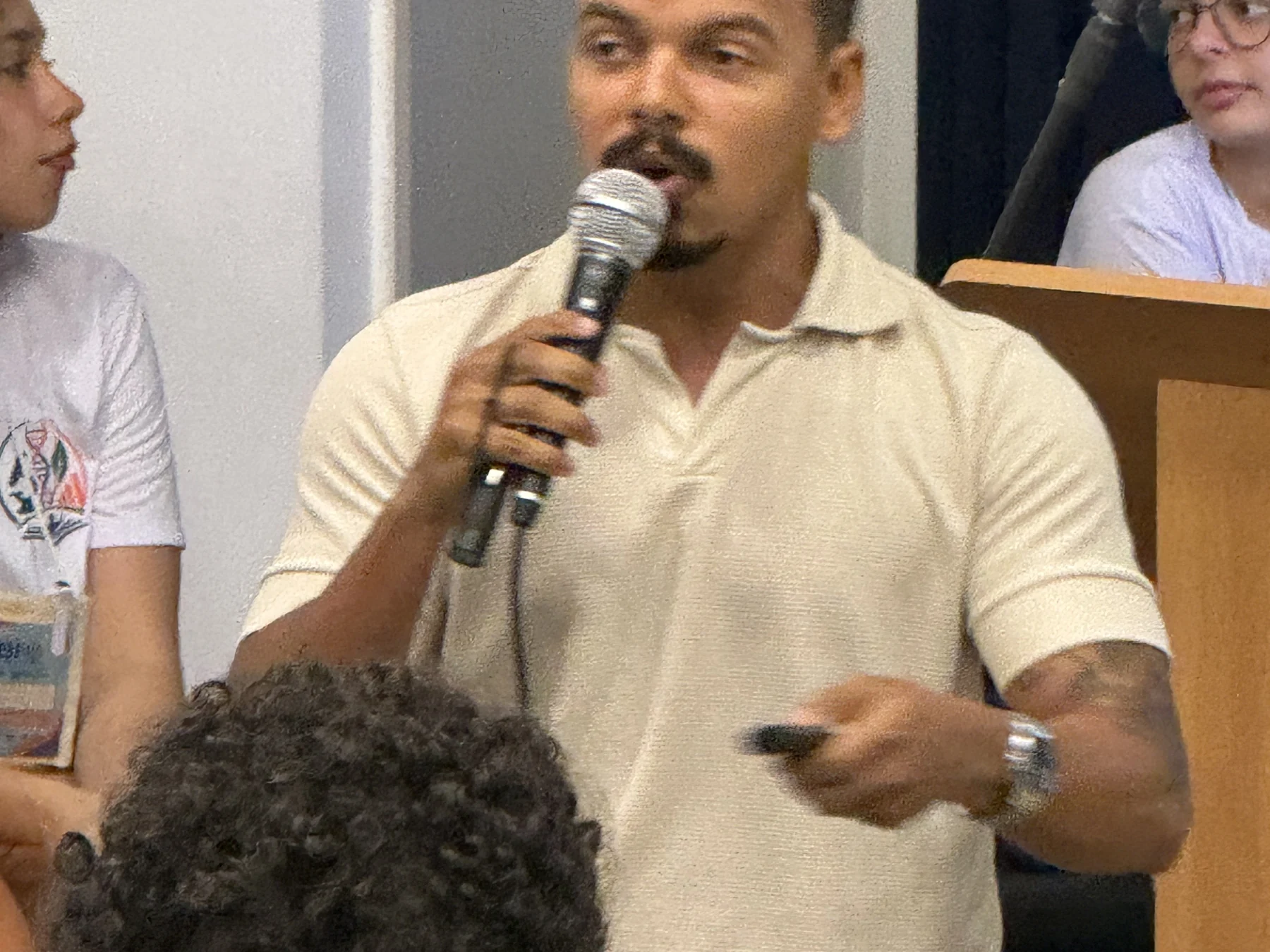 Palestrante conduzindo uma apresentação em auditório universitário.